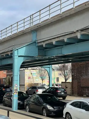 Under the tracks, urban life unfolds.